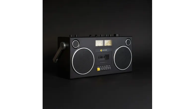 Angled product view of the black portable boombox emphasising the speaker grilles and cassette controls Angled product view of the black portable boombox emphasising the speaker grilles and cassette controls