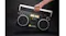 Hand carrying the We Are Rewind Blaster Curtis boombox by its handle, showcasing portability and retro styling Hand carrying the We Are Rewind Blaster Curtis boombox by its handle, showcasing portability and retro styling