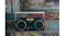 Front view of the black Bluetooth boombox displayed against a graffiti-covered urban backdrop Front view of the black Bluetooth boombox displayed against a graffiti-covered urban backdrop