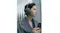 Side portrait of woman in coat wearing Sony olive grey headphones Side portrait of woman in coat wearing Sony olive grey headphones