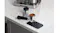 Espresso portafilter filled with coffee grounds resting on a black Ninja tamping mat Espresso portafilter filled with coffee grounds resting on a black Ninja tamping mat