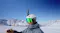 Snowboarder wearing a white helmet with a 360-action camera mounted on top against snowy mountains Snowboarder wearing a white helmet with a 360-action camera mounted on top against snowy mountains