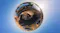 Tiny planet 360 projection of a person standing atop a desert rock formation surrounded by calm water Tiny planet 360 projection of a person standing atop a desert rock formation surrounded by calm water