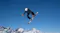Snowboarder catching air above snowy mountains while extending a selfie stick with an action camera attached Snowboarder catching air above snowy mountains while extending a selfie stick with an action camera attached