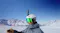 Snowboarder wearing a white helmet with a 360-action camera mounted on top against snowy mountains Snowboarder wearing a white helmet with a 360-action camera mounted on top against snowy mountains