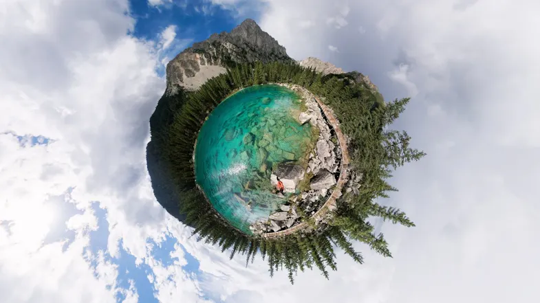 360-degree tiny planet perspective of a turquoise mountain lake surrounded by evergreen trees and clouds 360-degree tiny planet perspective of a turquoise mountain lake surrounded by evergreen trees and clouds