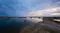 A panoramic view of a desert lake landscape reflecting a soft pink and blue sunset sky A panoramic view of a desert lake landscape reflecting a soft pink and blue sunset sky