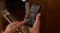 A person holding a smartphone displaying a smart oven cooking app with a 35.3 degree temperature reading A person holding a smartphone displaying a smart oven cooking app with a 35.3 degree temperature reading