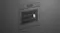 Angled view of a sleek grey built-in oven with an illuminated interior and digital display Angled view of a sleek grey built-in oven with an illuminated interior and digital display