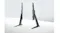 Pair of black tabletop TV support legs standing on white surface against grey backdrop Pair of black tabletop TV support legs standing on white surface against grey backdrop