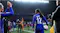 Soccer players on a pitch showcasing a stadium backdrop during a match Soccer players on a pitch showcasing a stadium backdrop during a match