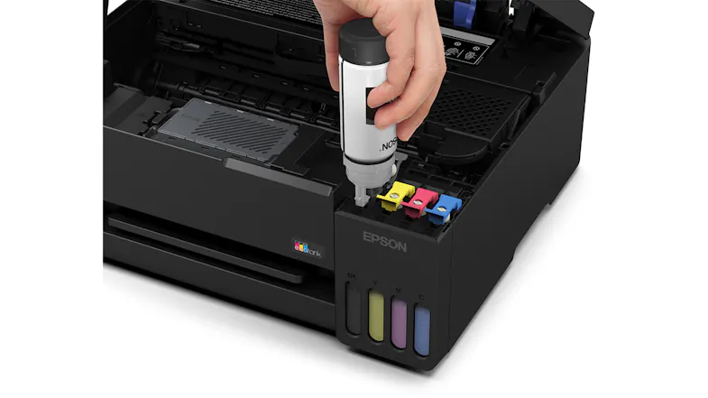 Close-up view of Epson printer showing ink bottle refilling process Close-up view of Epson printer showing ink bottle refilling process