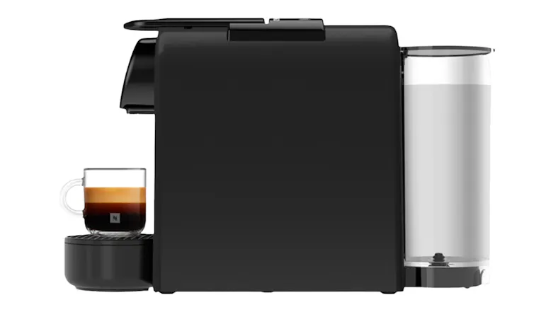 Side view of black DeLonghi Essenza Mini machine holding a clear mug of fresh espresso Side view of black DeLonghi Essenza Mini machine holding a clear mug of fresh espresso