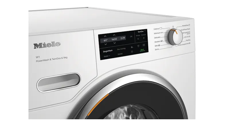 Close-up view of the washing machine display panel with control dial Close-up view of the washing machine display panel with control dial