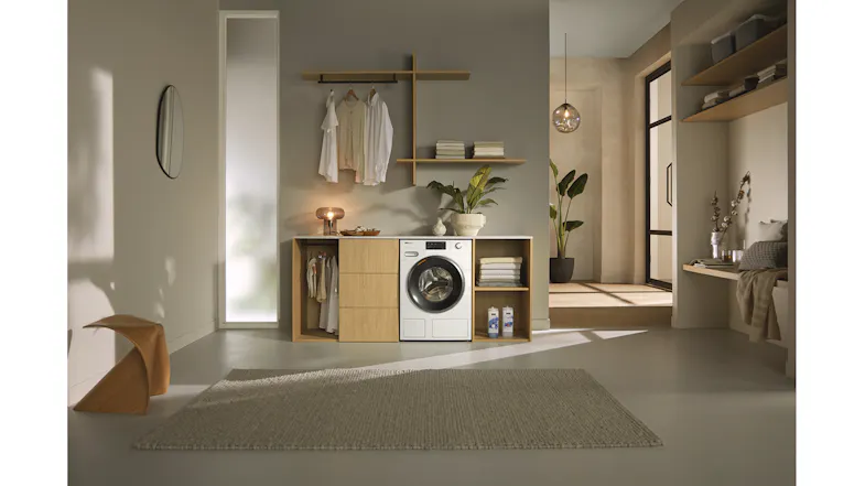 Laundry room setup featuring an integrated white washing machine Laundry room setup featuring an integrated white washing machine