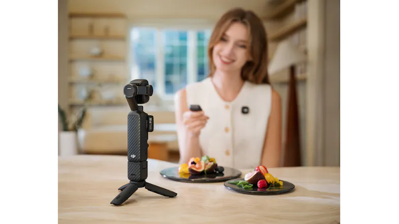 A woman eating at a table featuring the camera mounted on a mini tripod A woman eating at a table featuring the camera mounted on a mini tripod