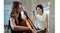 Indoor shot of a woman filming a cellist, highlighting handheld recording Indoor shot of a woman filming a cellist, highlighting handheld recording