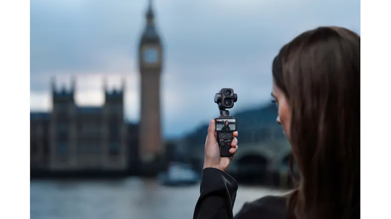 Evening view of a woman holding the gimbal camera outdoors Evening view of a woman holding the gimbal camera outdoors