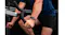 Close-up of a wrist wearing the smartwatch while gripping exercise equipment, highlighting its sporty design Close-up of a wrist wearing the smartwatch while gripping exercise equipment, highlighting its sporty design