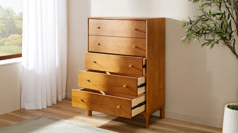 Five-drawer wooden chest with warm finish and brass-look handles, shown with three drawers open Five-drawer wooden chest with warm finish and brass-look handles, shown with three drawers open