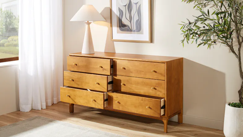 Six-drawer wooden dresser with warm finish and brass-look handles, shown with multiple drawers open Six-drawer wooden dresser with warm finish and brass-look handles, shown with multiple drawers open