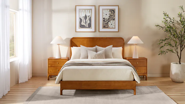 Full bedroom view showing wooden bed with matching nightstands and lamps Full bedroom view showing wooden bed with matching nightstands and lamps