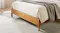 Low-angle view of the bed frame featuring light wood tone Low-angle view of the bed frame featuring light wood tone