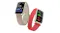 Two smartwatches displayed together, showcasing cream silicone and red woven band options Two smartwatches displayed together, showcasing cream silicone and red woven band options