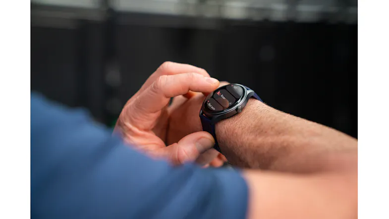 Detailed view of a wrist wearing the smartwatch while adjusting settings on the round display Detailed view of a wrist wearing the smartwatch while adjusting settings on the round display