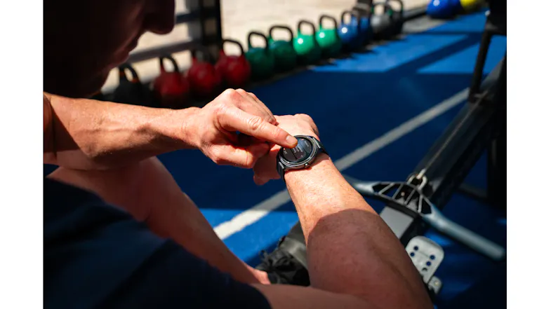 Close-up of the Ryze Flex (Gen 2) SmartWatch in use during training, with the wearer tapping the touchscreen Close-up of the Ryze Flex (Gen 2) SmartWatch in use during training, with the wearer tapping the touchscreen