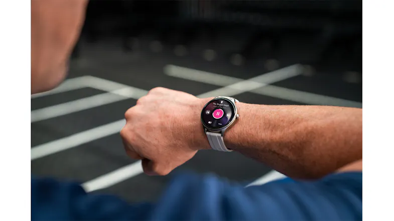 Close-up of the smartwatch worn during exercise, showing the round touchscreen display Close-up of the smartwatch worn during exercise, showing the round touchscreen display