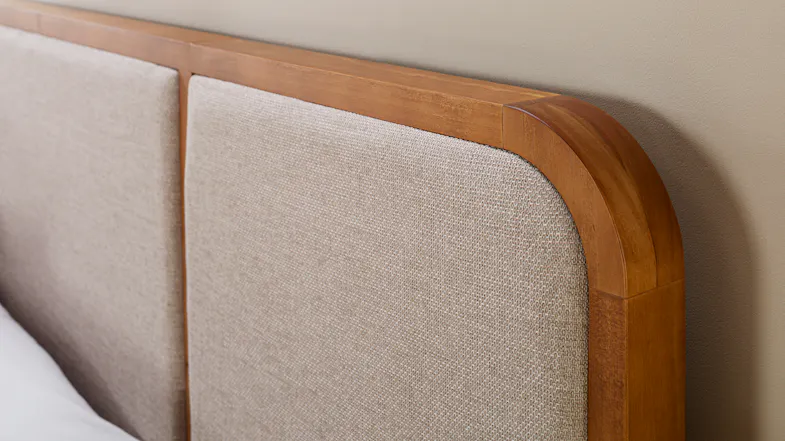 Detailed close-up of the headboard, highlighting the smooth timber frame and rounded corner profile Detailed close-up of the headboard, highlighting the smooth timber frame and rounded corner profile