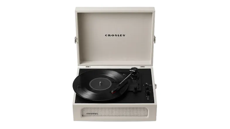 Cream portable record player with open lid, built-in speaker grille and vinyl record Cream portable record player with open lid, built-in speaker grille and vinyl record