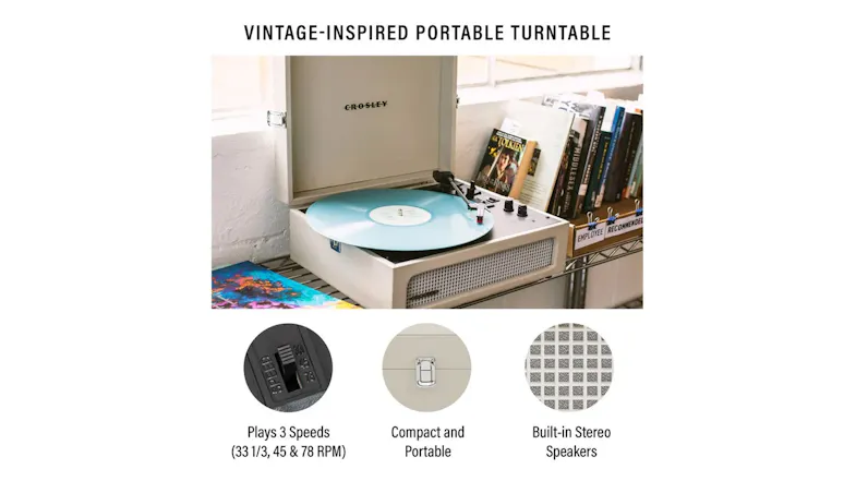 Cream vintage-style portable turntable playing a blue vinyl record Cream vintage-style portable turntable playing a blue vinyl record