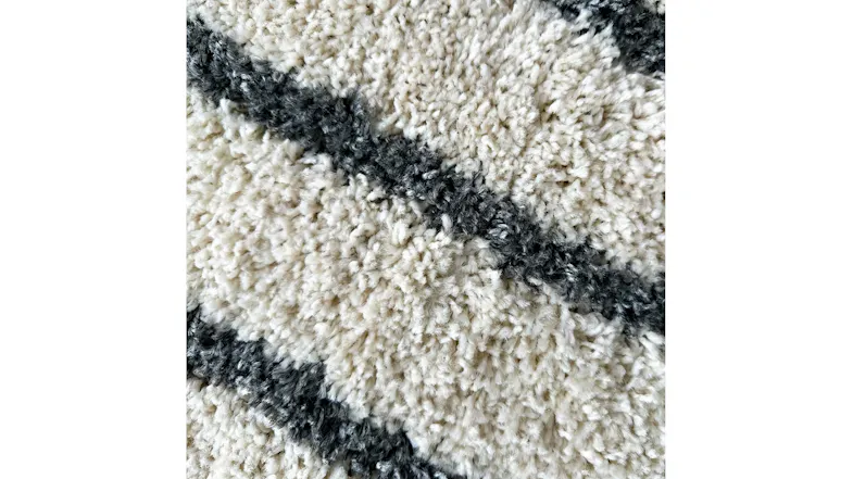 Close-up view of the rug showing soft striped fibres Close-up view of the rug showing soft striped fibres
