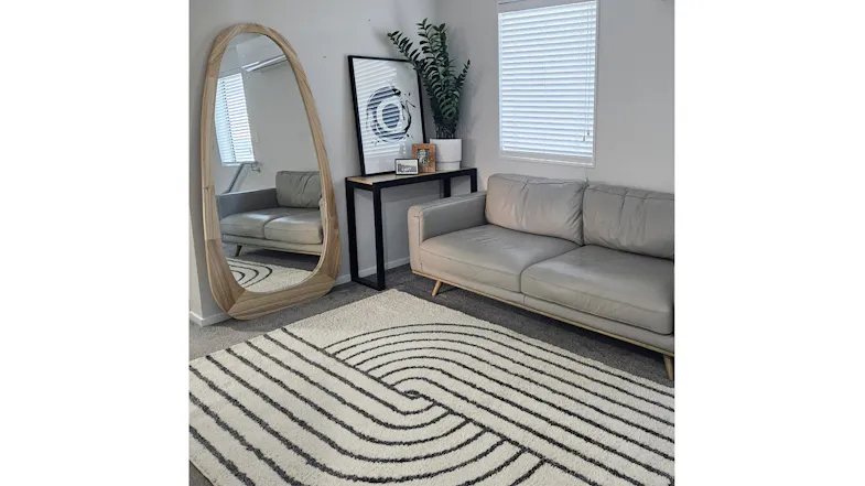 Beaumont Modern Rug styled in a contemporary living room beside a sofa and mirror Beaumont Modern Rug styled in a contemporary living room beside a sofa and mirror