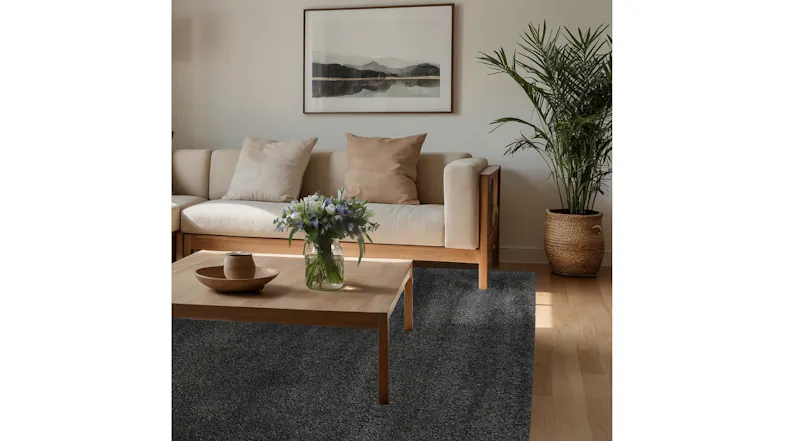 Remi Rug in Carbon styled in a modern living room beneath a timber coffee table Remi Rug in Carbon styled in a modern living room beneath a timber coffee table