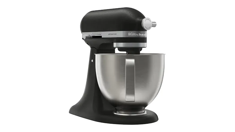 Rear angle view of the matte black KitchenAid Artisan Plus stand mixer with a stainless steel bowl and visible handle Rear angle view of the matte black KitchenAid Artisan Plus stand mixer with a stainless steel bowl and visible handle