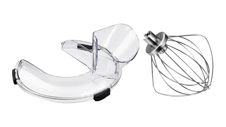 Angled view of a clear pouring shield and stainless steel wire whisk attachment for a KitchenAid mixer Angled view of a clear pouring shield and stainless steel wire whisk attachment for a KitchenAid mixer