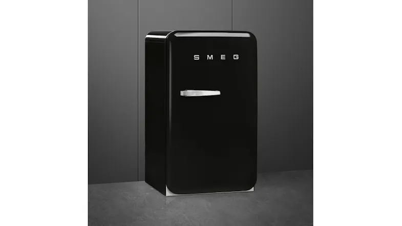 Front left view of a black SMEG mini refrigerator with a retro design and chrome handle Front left view of a black SMEG mini refrigerator with a retro design and chrome handle