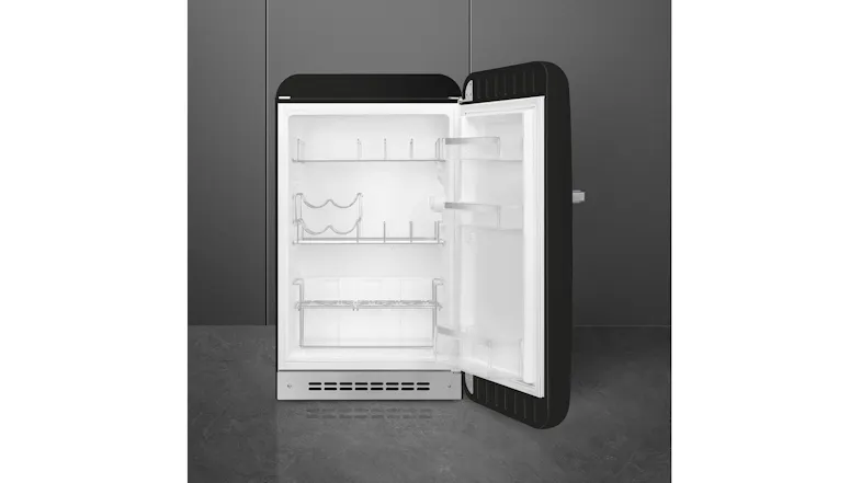 Front view of a black SMEG minibar fridge with the door open, showing white interior shelves and door racks Front view of a black SMEG minibar fridge with the door open, showing white interior shelves and door racks
