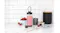 Nutribullet blender cup filled with a pink smoothie, displayed next to its gunmetal grey base, strawberries, and chocolate on a marble countertop Nutribullet blender cup filled with a pink smoothie, displayed next to its gunmetal grey base, strawberries, and chocolate on a marble countertop