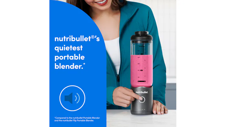 Woman pressing the power button on a gunmetal grey Nutribullet portable blender filled with a pink smoothie Woman pressing the power button on a gunmetal grey Nutribullet portable blender filled with a pink smoothie