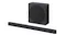 Angled view of the TCL black soundbar and wireless subwoofer showing a side port and rounded cabinet design Angled view of the TCL black soundbar and wireless subwoofer showing a side port and rounded cabinet design