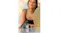 Charcoal and white Shark cooling devices resting on a white tabletop beside a gold-rimmed mirror, with a woman blurred in the background Charcoal and white Shark cooling devices resting on a white tabletop beside a gold-rimmed mirror, with a woman blurred in the background