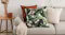 Modern living room setup showing the green leaf Toledo cushion arranged on a sofa next to neutral cushions Modern living room setup showing the green leaf Toledo cushion arranged on a sofa next to neutral cushions
