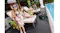 Lifestyle scene showing the pool cleaner operating near a pool while people relax poolside Lifestyle scene showing the pool cleaner operating near a pool while people relax poolside