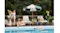 Wide lifestyle view of a residential swimming pool with the Aiper Scuba X1 Pro Max operating in the water Wide lifestyle view of a residential swimming pool with the Aiper Scuba X1 Pro Max operating in the water