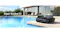 Aiper Scuba S3 robotic pool cleaner positioned beside a modern swimming pool, showcasing the sleek black design Aiper Scuba S3 robotic pool cleaner positioned beside a modern swimming pool, showcasing the sleek black design