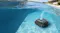 Robotic pool cleaner cleaning the floor of a swimming pool, showcasing autonomous operation Robotic pool cleaner cleaning the floor of a swimming pool, showcasing autonomous operation